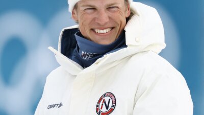Gold medallist Norway's Johannes Hoesflot Klaebo smiles as he celebrates during a podium ceremony for the men's cross country 50km mass start final event of the Milano Cortina 2026 Winter Olympic Games at Tesero Cross-Country Skiing Stadium in Lago di Tesero (Val di Fiemme) on February 21, 2026.