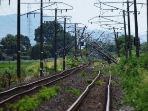 Electric poles are seen fallen over rail tracks in Hikawa, southern Japan, Thursday, July 30, 2026, two days after an earthquake hit the area.