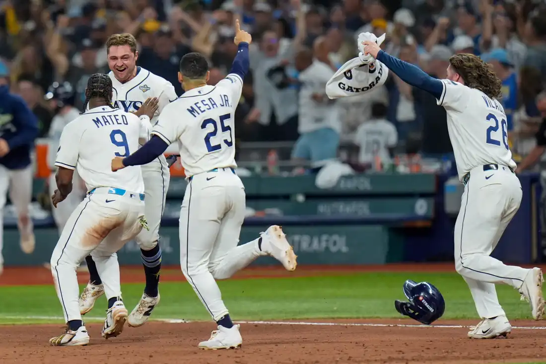 Tampa Bay Rays shortstop Jorge Mateo (9) and right fielder Victor Mesa Jr. (25) celebrate with Tampa Bay Rays second baseman Ben Williamson after his walk-off RBI single during the 12th inning of Game 4 of baseball's World Series, Wednesday, Oct. 28, 2026, in St. Petersburg, Fla., between the Milwaukee Brewers and the Tampa Bay Rays.