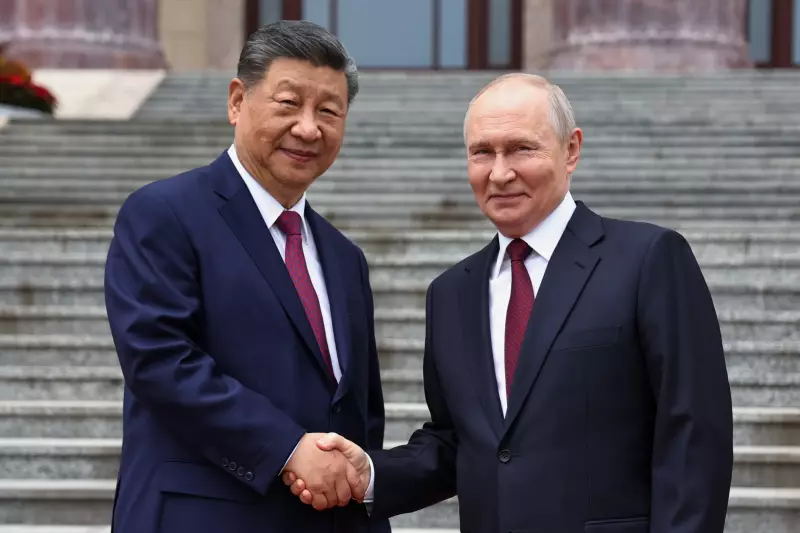 Russian President Vladimir Putin, right, and Chinese President Xi Jinping shake hands during a welcome ceremony at the Great Hall of the People, in Beijing, China, on Wednesday, May 20, 2026.