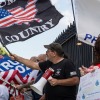 Demonstrators wave flags at a rally in support of Immigration and Customs Enforcement (ICE) at the State House in Augusta, Maine, on July 15.