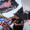 Demonstrators wave flags at a rally in support of Immigration and Customs Enforcement (ICE) at the State House in Augusta, Maine, on July 15.