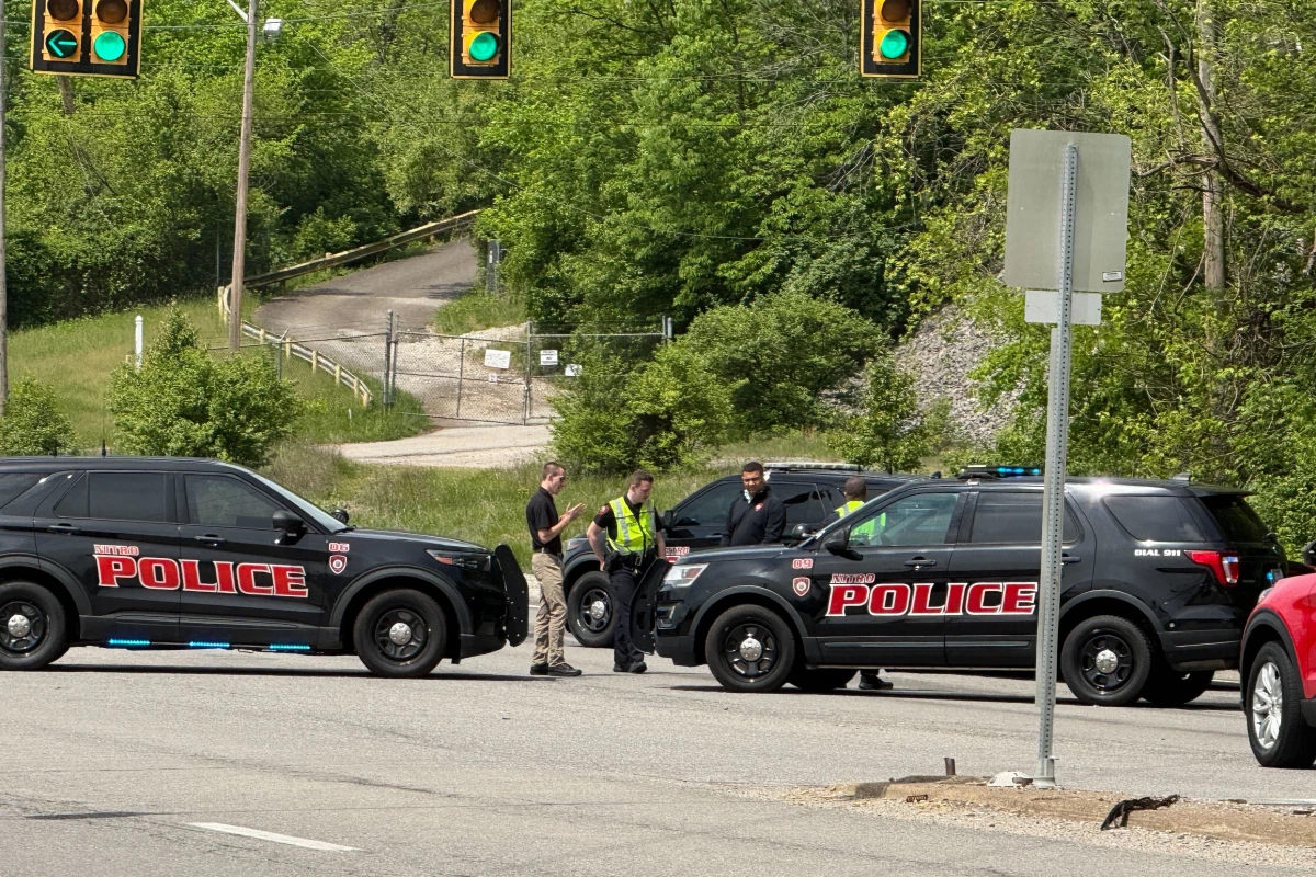 Police block a road near a chemical plant where a leak occurred Wednesday in Institute, W.Va.