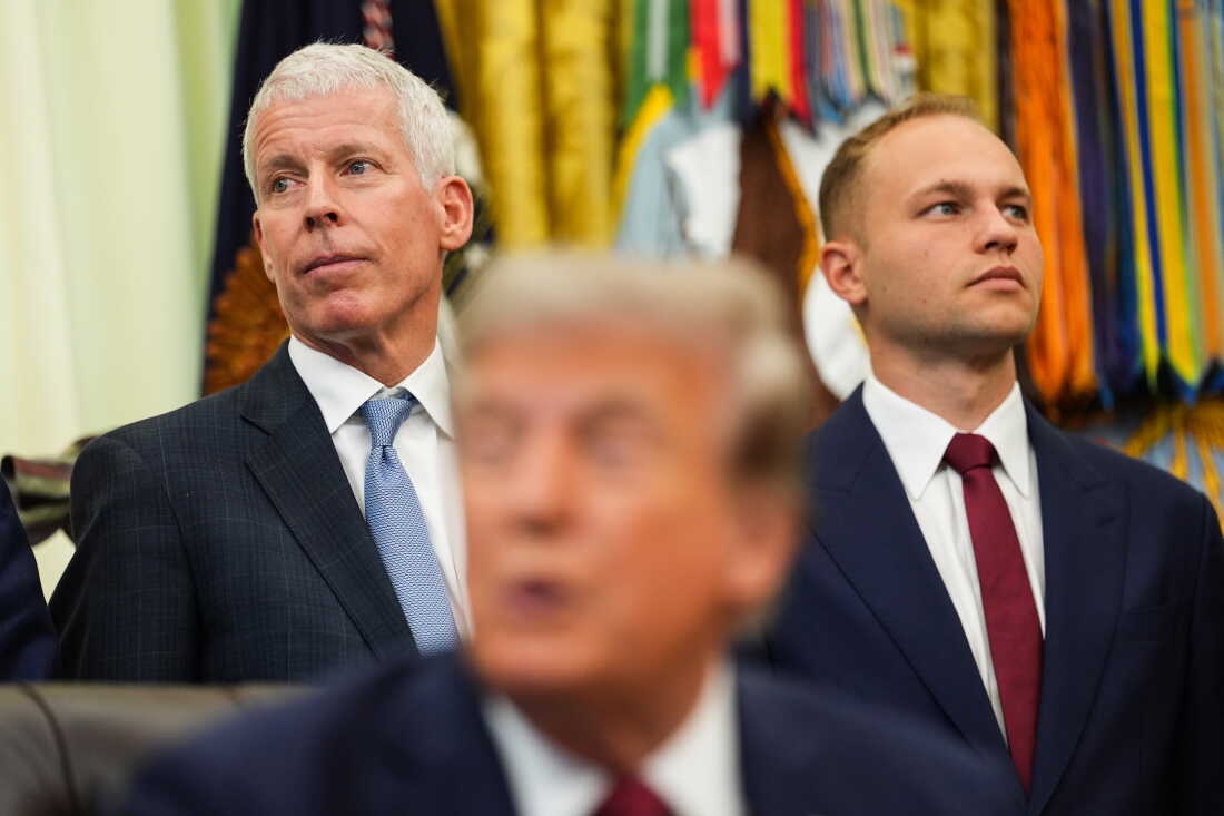 Valar Atomics CEO Isaiah Taylor (on the right side of the frame) and Energy Secretary Chris Wright (on the left side of the frame) stand behind President Trump, who is seated at a desk, as he makes an announcement on American nuclear innovation on July 24.