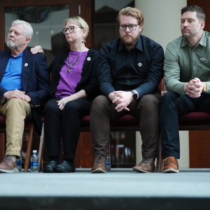 The family of Renee Good, from left; father Tim Ganger, mother Donna Ganger, brother Luke Ganger and brother Brent Ganger, listen during a news conference after the family sued the U.S. government and several immigration officials, Thursday, Oct. 1, 2026, in Minneapolis.