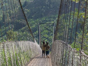 Two youngsters cross the Cyangoga Suspension Bridge.