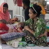 Thirteen-month-old Jannat cries as her mother Sohana, a garment worker, tries to feed her. The child is hospitalized for measles at DNCC Hospital in Dhaka, Bangladesh.