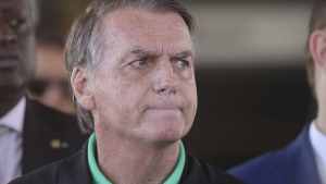 Brazil's former President Jair Bolsonaro gives a press conference outside the Senate in Brasilia.