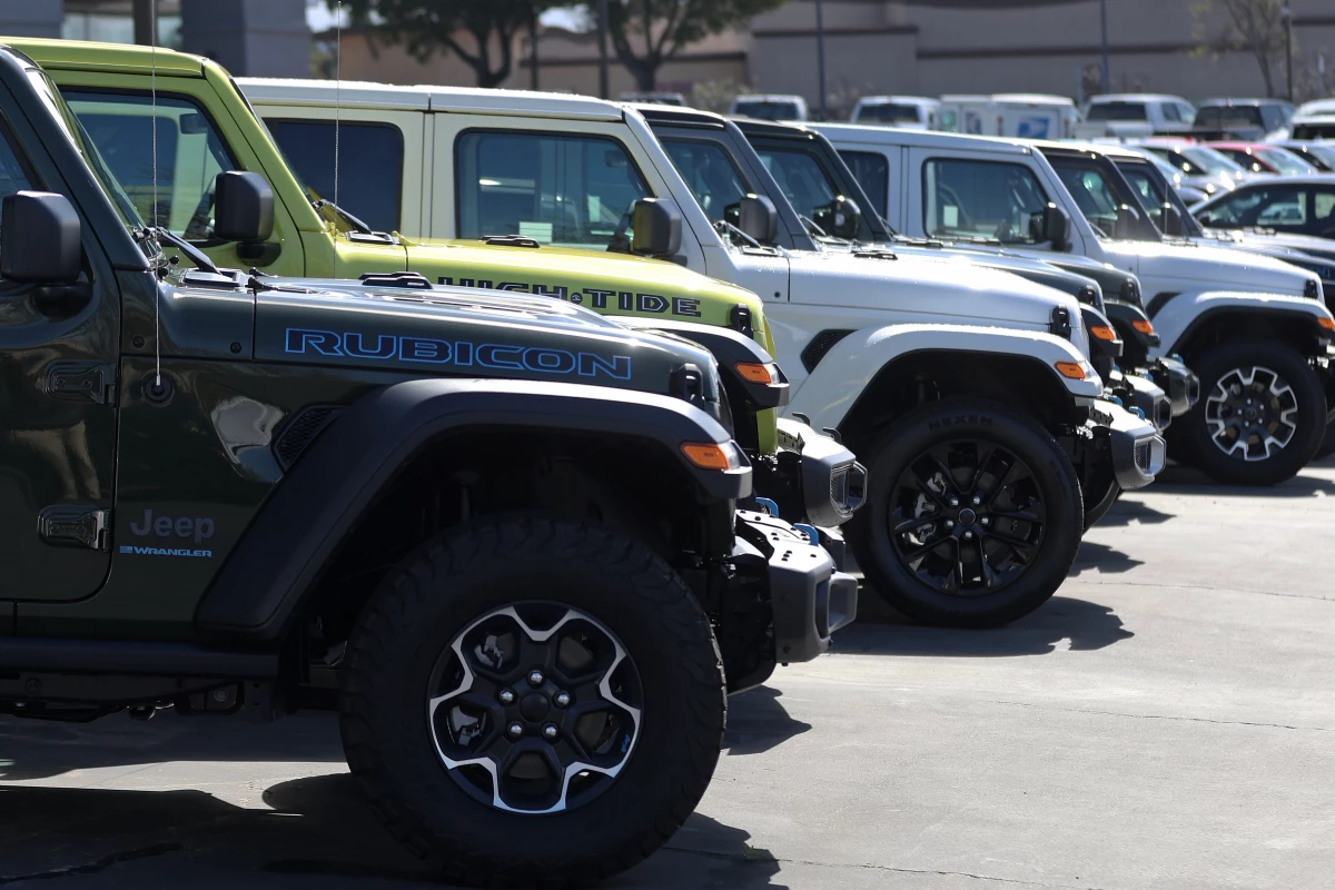 Jeep Wrangler 4Xe plug-in hybrids displayed on the sales lot at Hilltop Chrysler Jeep Dodge Ram in Richmond, California.