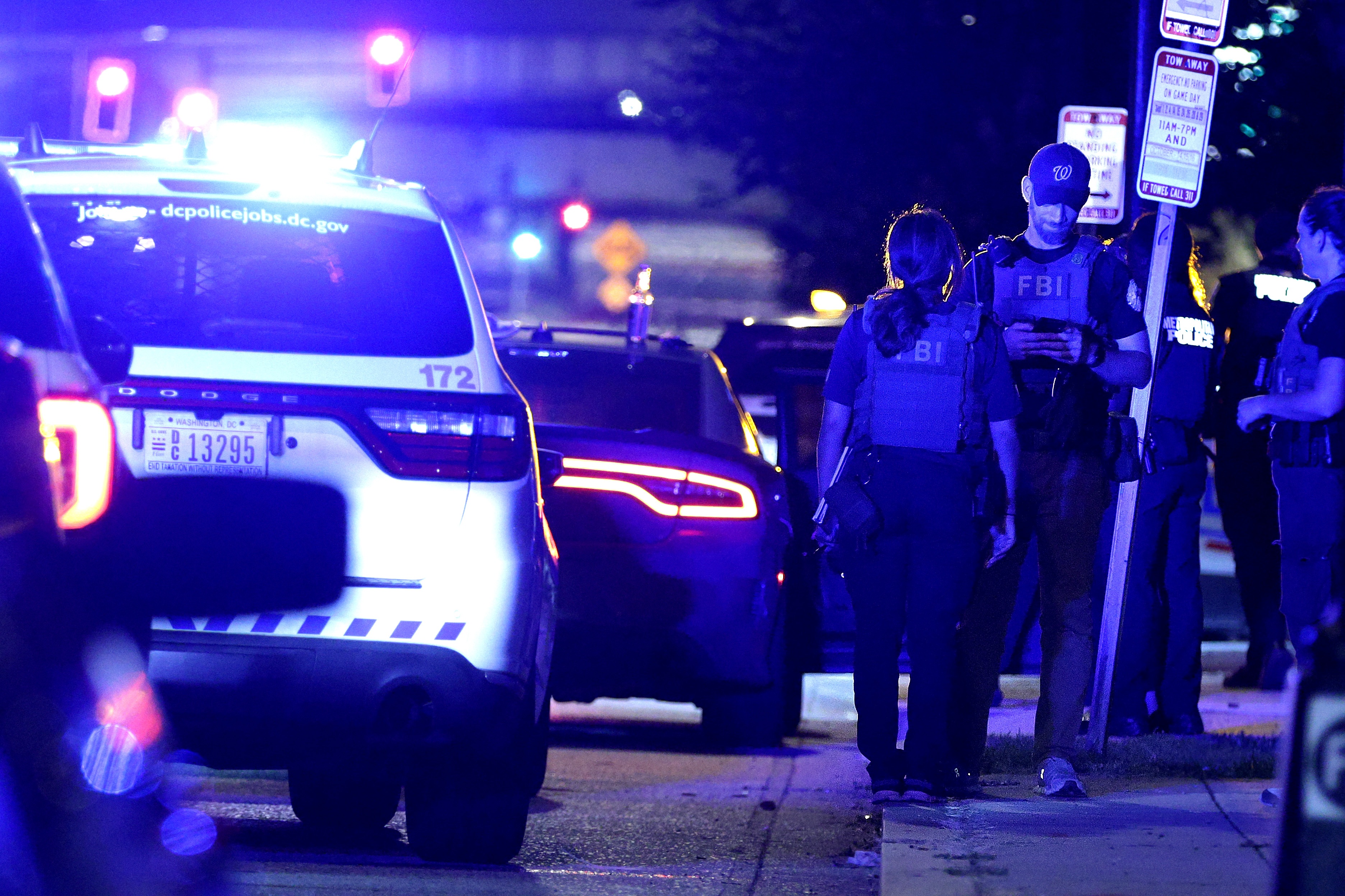 Federal and local law enforcement officers investigate a suspect's vehicle on South Capitol Street in Washington, D.C., on Aug. 11. (Getty Images)