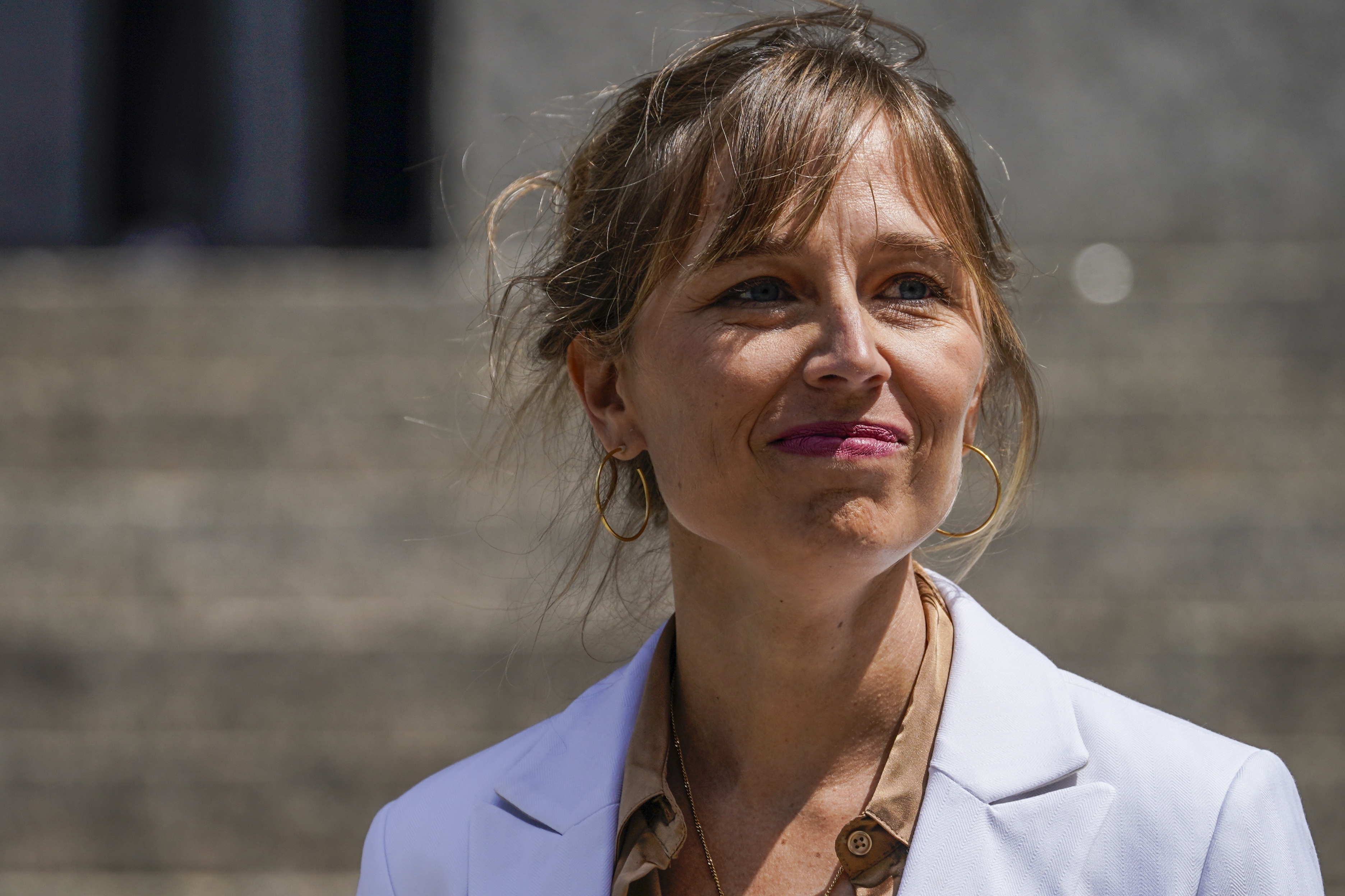 Annie Farmer, one of the four accusers who testified against Ghislaine Maxwell at trial, walks towards waiting reporters outside federal court, Tuesday, June 28, 2022, in New York. (AP)