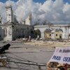 People walk past damage from Hurricane Melissa in Black River, Jamaica on Thursday, Oct. 30, 2025. 