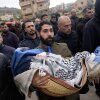 A Palestinian man carries Muhammad Bani Odeh, 5, at the funeral of four members of the Odeh family who were killed in their car by Israeli security forces during an army operation in Tammun, West Bank, Sunday, March 15, 2026. 