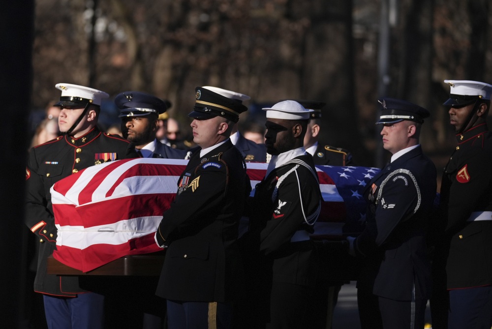 A military body bearer team carries the casket of former President Jimmy Carter into the Jimmy Carter Presidential Library and Museum to lie in repose in Atlanta. (Pool AP)