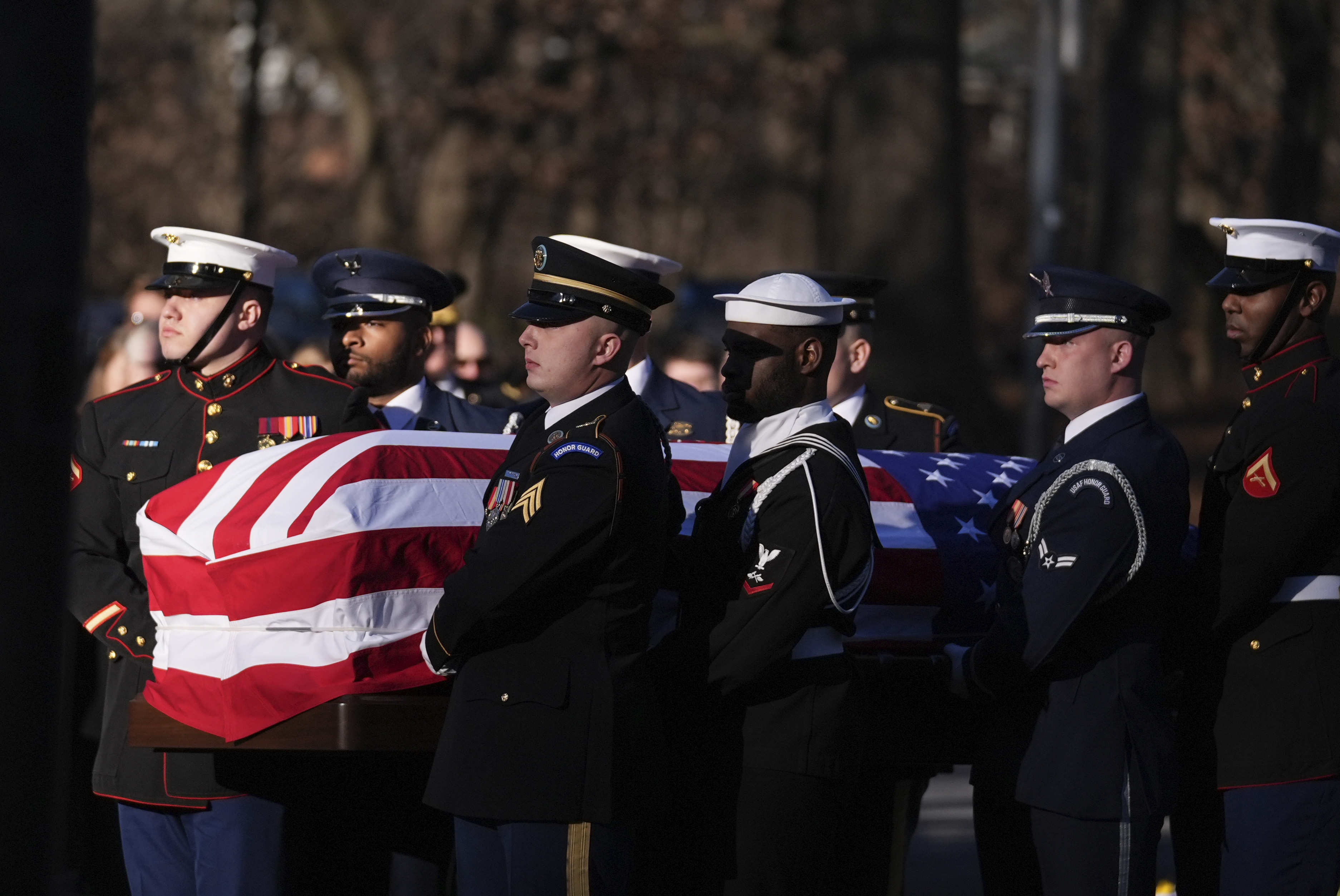 A military body bearer team carries the casket of former President Jimmy Carter into the Jimmy Carter Presidential Library and Museum to lie in repose in Atlanta. (Pool AP)