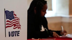 A Fulton County staff member works as people vote in a runoff election, TJune 16, 2026 in Atlanta.