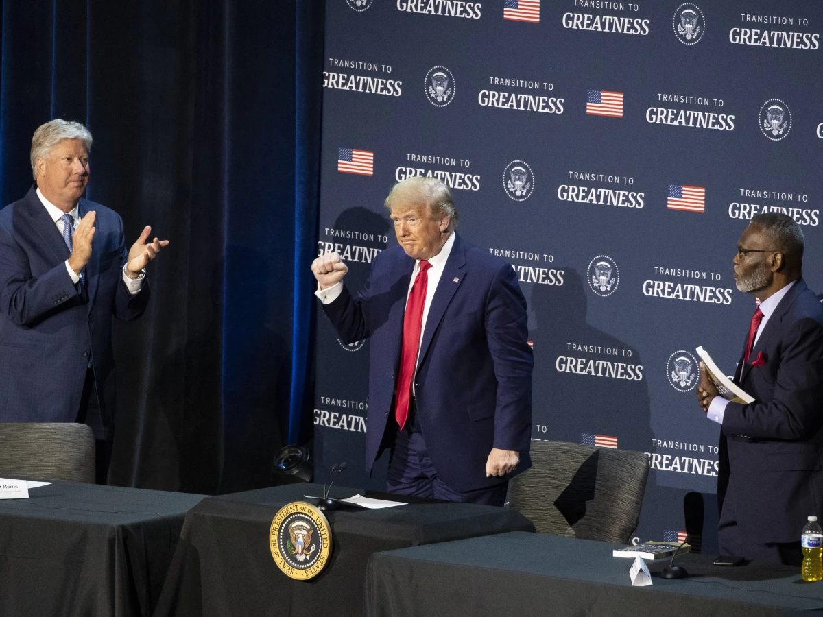 Pastor Robert Morris, left, and Bishop Harry Jackson, senior pastor at Hope Christian Church in Beltsville, Md., right, applaud after President Donald Trump spoke during a roundtable discussion about 'Transition to Greatness: Restoring, Rebuilding, and Renewing,' at Gateway Church in Dallas on June 11, 2020.