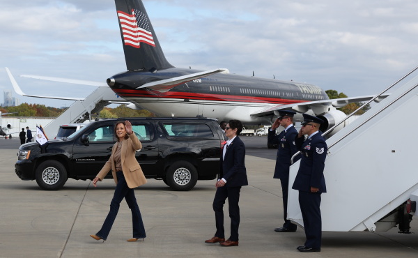 Democratic presidential nominee, Vice President Harris, arrives at Charlotte Douglas International Airport next to the airplane of Republican presidential nominee, former President Donald Trump, on Saturday. Both candidates are in the pivotal state of North Carolina to close out their presidential campaigns.