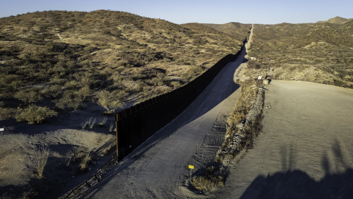 In this aerial view, the U.S.-Mexico border wall ends with a gap on Sunday near Sasabe, Ariz. Although immigrant crossings are down sharply, the incoming Trump administration has vowed to complete the wall and 'seal' the border completely.