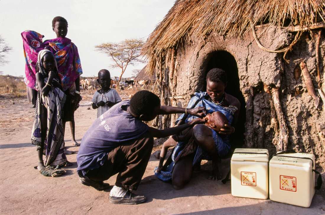 UNICEF, WHO, USAID and local Sudanese volunteers collaborate to facilitate a vaccination program, reaching hundreds of children living in inaccessible areas. The medical teams walk for days through swamps and bush, carrying the cold boxes that hold the vaccines. (Photo by Wendy Stone/Corbis via Getty Images)