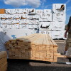 Mel Gutherie, president of Gutherie Lumber, walks among Canadian lumber products on Aug. 25 in Livonia, Mich.