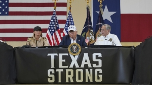 President Donald Trump speaks as first lady Melania Trump, left, and Texas Gov. Greg Abbott listen during a roundtable discussion with first responders and local officials at Hill Country Youth Event Center in Kerrville, Texas, during a tour to observe flood damage, Friday, July 11, 2025.