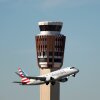 An American Eagle jet flies past the air traffic control tower at Phoenix Sky Harbor International Airport on, Nov. 8, 2025. As essential employees, controllers were required to work during the government shutdown without pay. When the last shutdown ended in 2019, it took some years to get all the money they were owed.