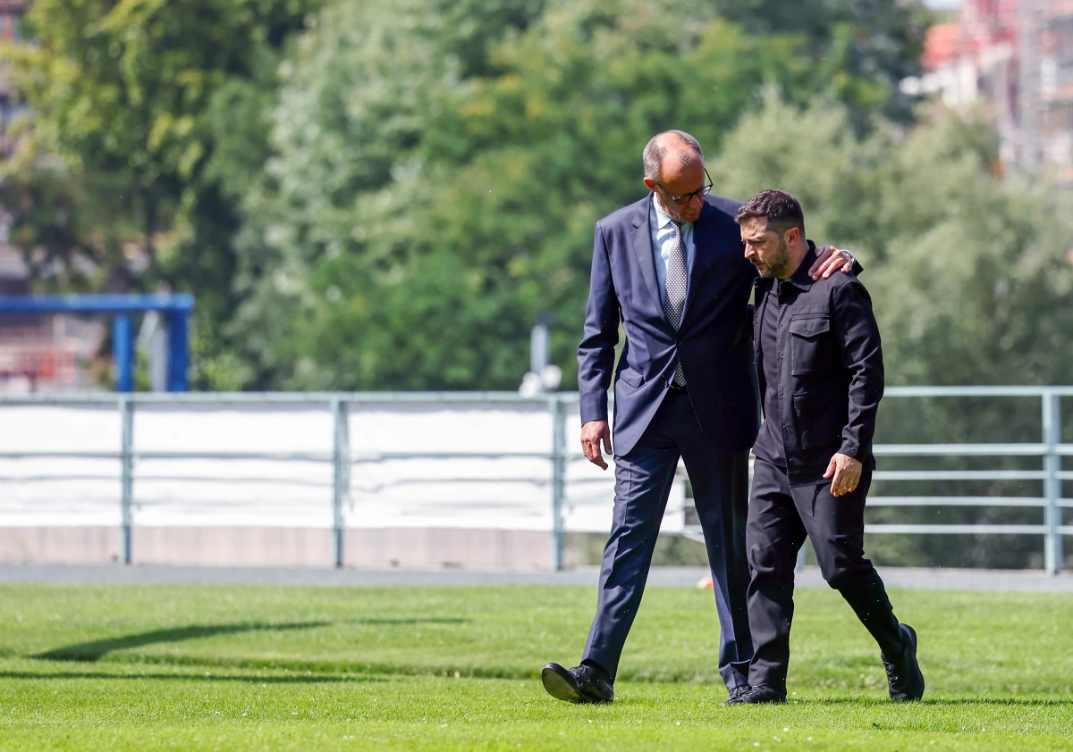 German Chancellor Friedrich Merz (L) welcomes Ukrainian President Volodymyr Zelensky (R) in front of Chancellery on August 13, 2025 in Berlin, Germany.