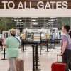 Travelers make their way to the gates during a temporary ground stop at the Nashville International Airport on October 7, 2025 in Nashville, Tennessee. The Federal Aviation Administration (FAA) notified the airport that flights arriving and departing would be reduced due to a shortage of air traffic controllers amid the ongoing federal government shutdown.