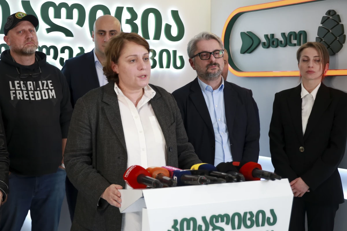 Elene Khoshtaria, chair of United National Movement, center, speaks to the media, accompanied by Zurab Japaridze, chairman of the Girchi More Freedom party, left; Nika Melia, a leader of Coalition for Changes, second left; Nika Gvaramia, leader of Coalition for Change, second right, and Nana Malashkhia, of Coalition for Change, right, in Tbilisi, Georgia, Sunday, Oct. 27, 2024.