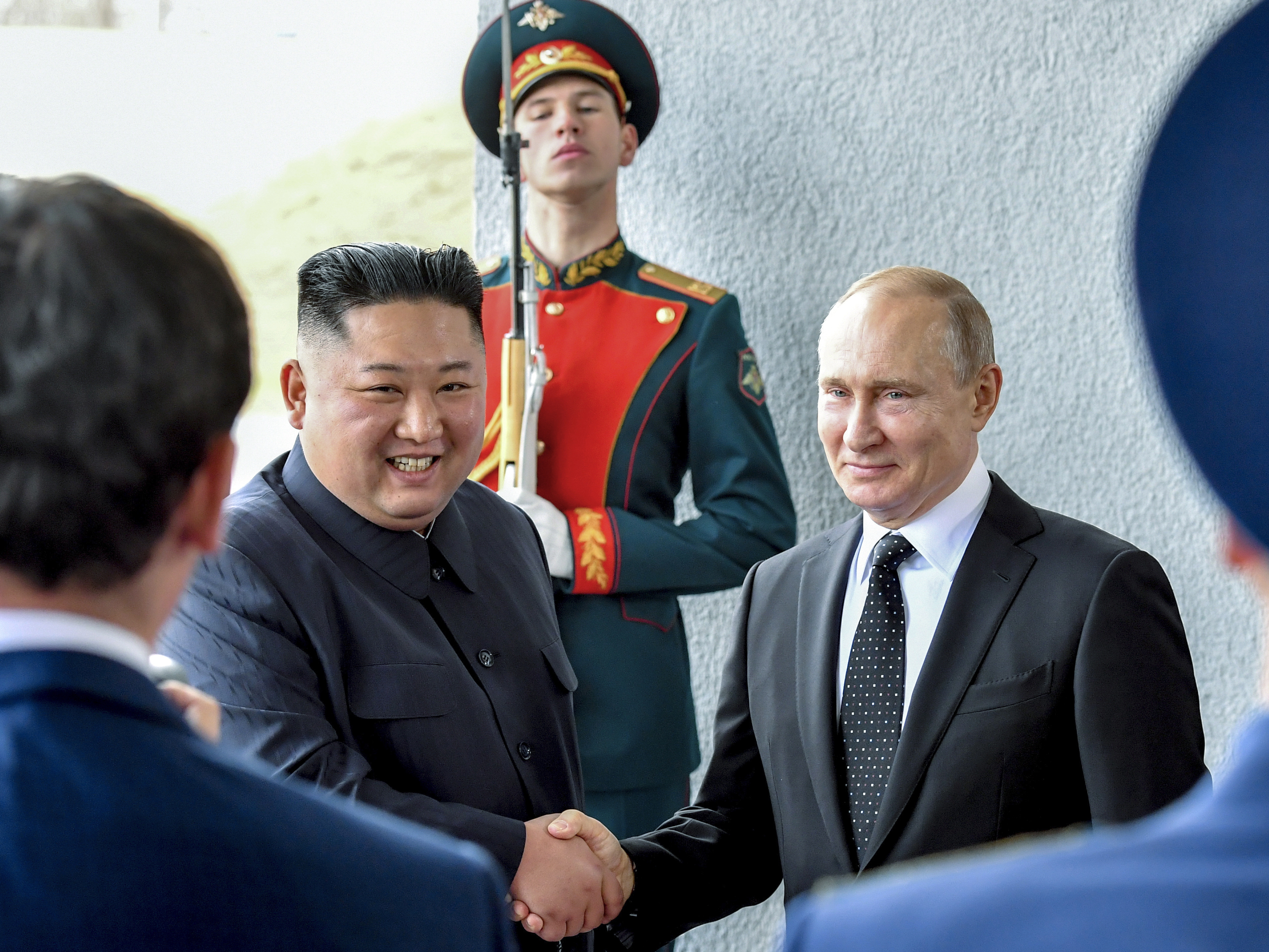 Russian President Vladimir Putin (center, right) and North Korea's leader Kim Jong Un shake hands during their meeting in Vladivostok, Russia, on April 25, 2019.
