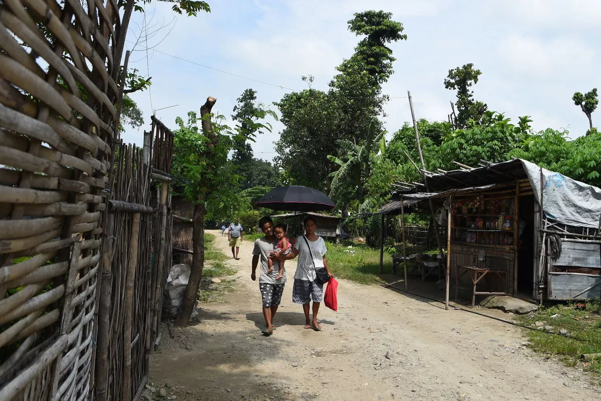 This picture taken on Aug. 10, 2018 shows members of a Nepali-speaking Bhutanese refugee family walking in a refugee camp in Damak, Nepal.