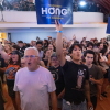 Supporters of Wisconsin Democratic gubernatorial candidate Francesca Hong cheer at her election night party on Tuesday in Madison. They are standing as a group, and two are holding up campaign signs.