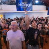 Supporters of Wisconsin Democratic gubernatorial candidate Francesca Hong cheer at her election night party on Tuesday in Madison. They are standing as a group, and two are holding up campaign signs.