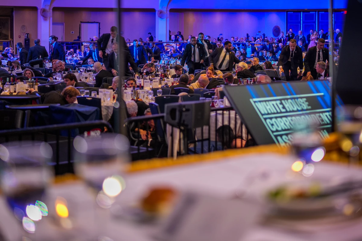 Secret Service agents rush into the ballroom at the Washington Hilton as attendees shelter on the floor.