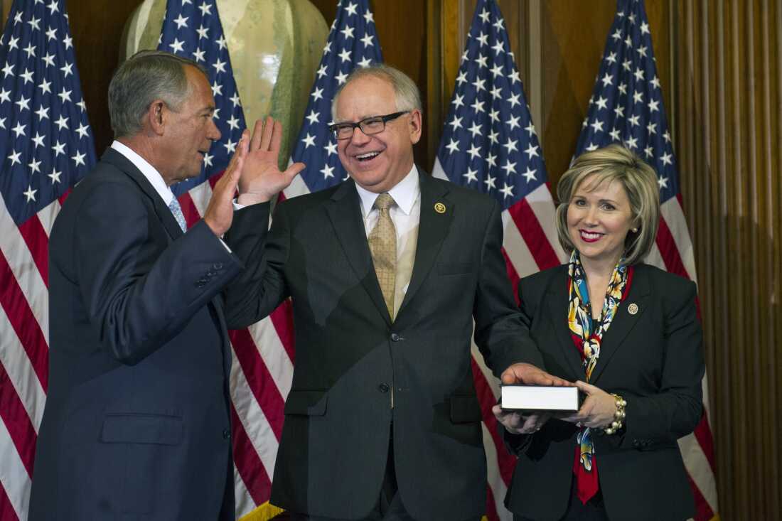 Then-House Speaker John Boehner of Ohio administers a ceremonial re-enactment of the House oath-of-office to then-Rep. Tim Walz, as Gwen watches, in 2015.