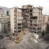 An excavator clears rubble from destroyed residential buildings in northern Tehran, Iran, on Monday, as the U.S. and Israel's war with Iran raged for its fourth week.