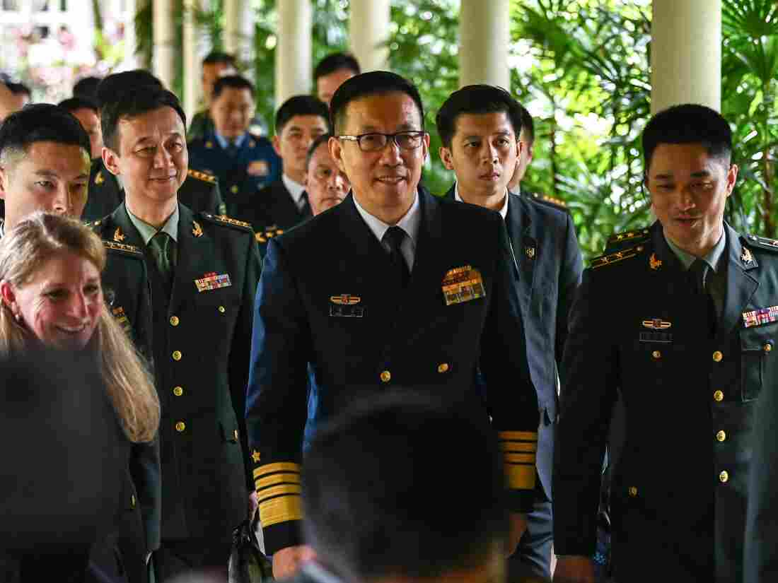 China's Defense Minister Dong Jun, center, walks out after a bilateral meeting with U.S. Secretary of Defense Lloyd Austin on the sidelines of the 21st Shangri-La Dialogue summit at the Shangri-La Hotel in Singapore on Friday.
