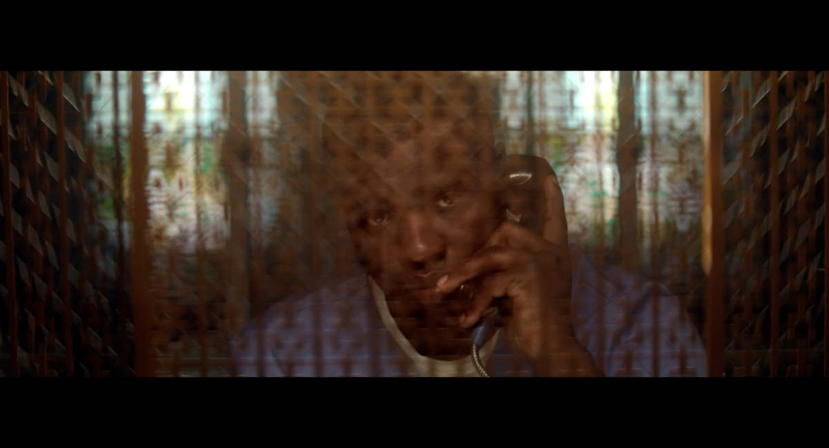 Hoy depicts an older Jacobs talking to his father through glass during a visitation. In the film, Jacobs says he had just finished writing two verses of his song 'Steel Grave,' and rapped both verses over the phone for his dad. When he finished, Jacobs says his father asked him, 'What happens to the character? You just described he was in this dark world. Does he ever come out?'