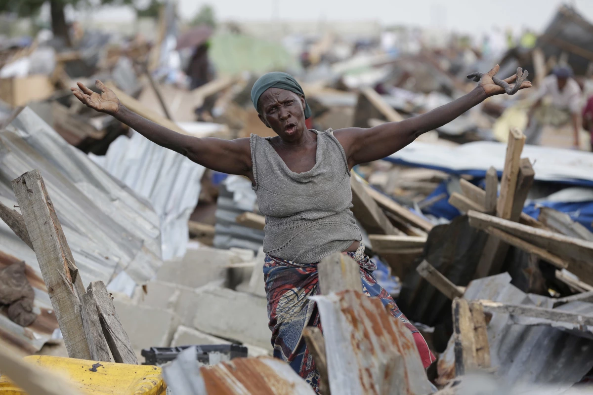 A woman gestures in front of her demolished house in Otodo-Gbame waterfront in Lagos, Nigeria. Saturday, March 18, 2017. Slums and shantytowns are often targeted in rampant demolitions across Africa's most populous country