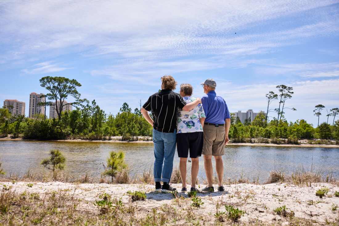 Colby, Kathy and Dick McCaskill look out over the water at their rental condo in Pensacola, Fla.