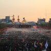 Large crowds of pilgrims fill the area between the two holy shrines in Karbala at sunset