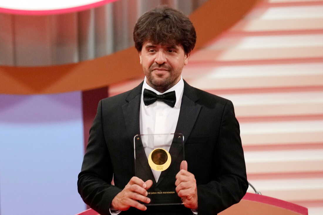 FILE - U.S. scientist Karl Deisseroth, professor of Departments of Bioengineering and Psychiatry at Stanford University, shows his trophy for "Life Sciences" field during the Japan Prize presentation ceremony Thursday, April 13, 2023, in Tokyo.