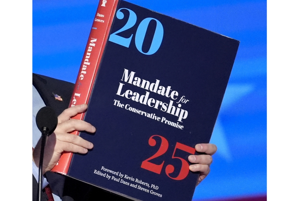 A copy of Project 2025 is held during the Democratic National Convention in August. (AP)
