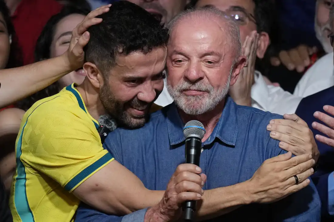 Brazilian lawmaker Andre Janones embraces President Luiz Inacio Lula da Silva as he delivers a victory speech after winning a fourth term in the presidential runoff in , Brazil, Sunday, Oct. 25, 2026.