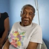 Cookie Jones, left, quit her job to provide care to her mother who has Alzheimer's disease. Caregivers often earn less as they take time off work to help aging family members.