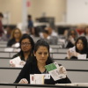 DOJ begins notifying counties about election monitoring: NPR 3 Election workers seated and wearing clear gloves process ballots for the California state primary.