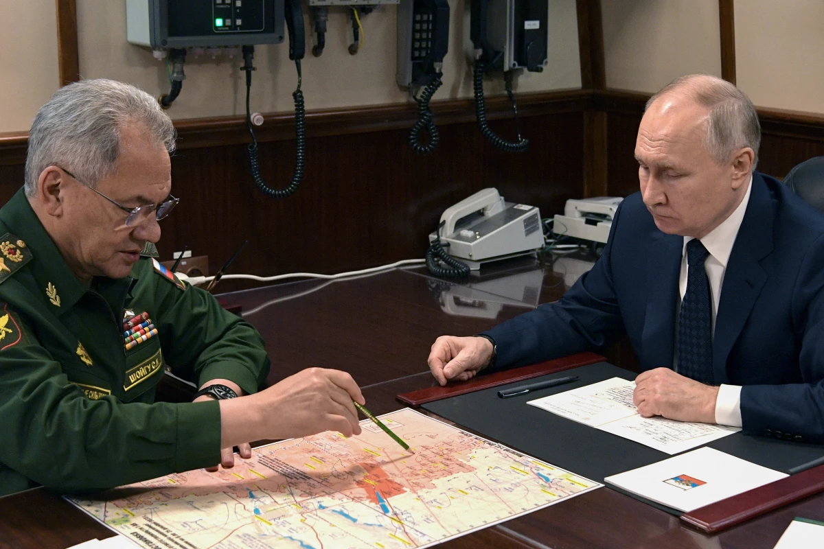 In this pool photograph distributed by Russian state agency Sputnik, Vladimir Putin and Russia's Defense Minister Sergei Shoigu meet in December, 2023