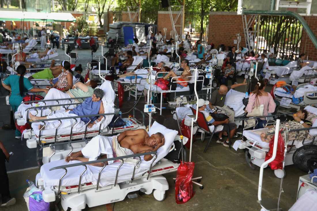 Patients from a clinic evacuated due to earthquake damage lie in beds at a temporary facility set up in a gymnasium at a nearby school in Cali, Colombia, Tuesday, Aug. 11, 2026.