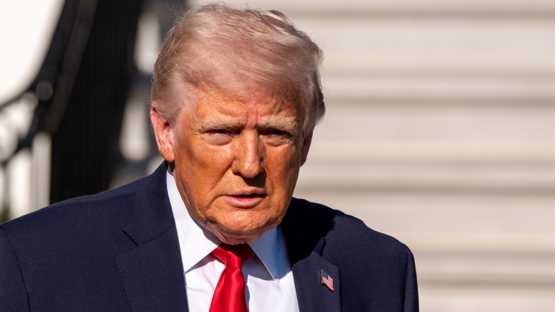 President Trump speaks with reporters before departing on Marine One from the South Lawn of the White House on April 11 in Washington.